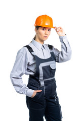 A female civil engineer is looking suspiciously at the camera. Isolated