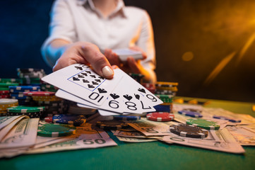 Game in a casino. The player takes everything from a winning combination. Poker game in a casino.