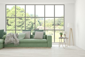 Stylish room in white color with sofa and summer landscape in window. Scandinavian interior design. 3D illustration