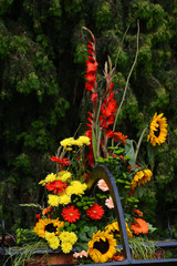Arrangement of flowers. Red gladiolus, sunflowers, gerbera, chrysanthemums.