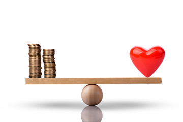 Heart and money on balance scale - Order of priority in life among love and money