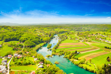 Fototapeta na wymiar Croatia, countryside landscape, Mreznica river from air, Belavici village, waterfalls in spring