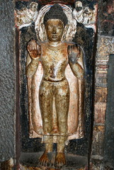 Standing Buddha with niche with flying figure holding garlands, Ajanta Caves, Maharashtra, India
