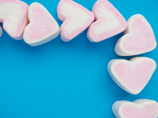 marshmallow snack in heart shape. Decorate design Love on trendy classic blue background. Heart...