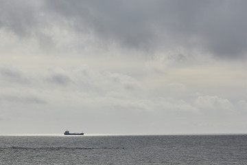 ship in the sea on a cloudy day.