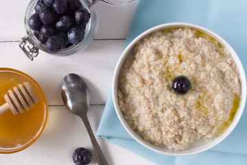 oatmeal with butter, tea and cookies on the table