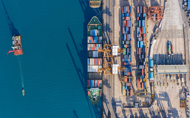 Aerial top view container cargo ship at terminal commercial port for business logistics, import export, shipping or transportation.