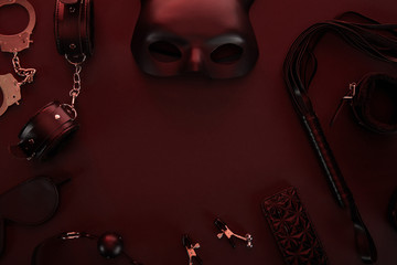top view of sex toys in dark lighting on red background