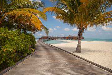 wooden bridge leading to the bungalows, a beautiful place in the Maldives