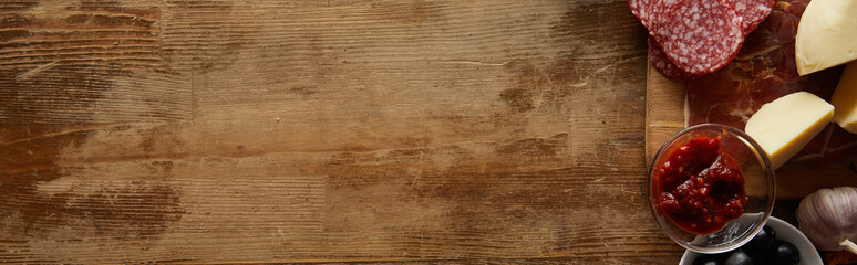 Top view of ingredients for pizza aside on wooden background, panoramic shot