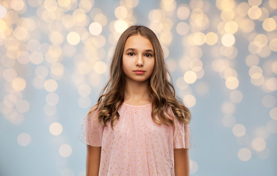 Fashion And People Concept - Young Teenage Girl In Party Dress Over Festive Lights Background
