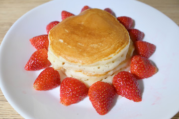 pancake and strawberry fruit sweet dessert food put on breakfast table