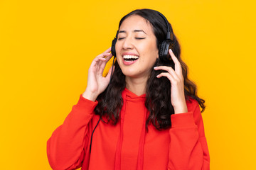 Mixed race woman wearing a red sweatshirt listening music and singing