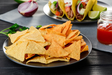 A plate of nachos in the foreground