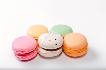 French colorful macarons background,Colorful macarons on white background. Macaron or Macaroon is sweet meringue-based confection. Flat lay