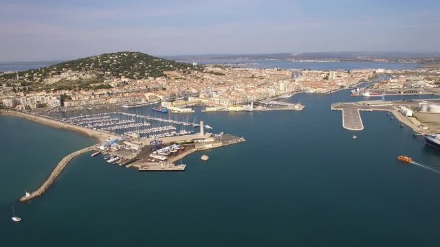 Zoom out, aerial view of the bay of Sete, south of France. Nice view of the harbor with sailboats and Mont Saint Clair in background.