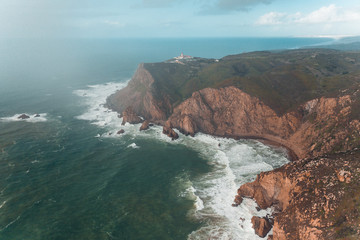 Fototapeta na wymiar Cabo da Roca Portugal from the above shore ocean lighthouse bay with waves and clouds