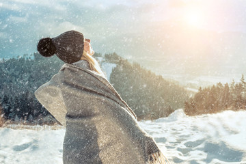 Happy woman traveler on the snowy of mountain look on the nice w