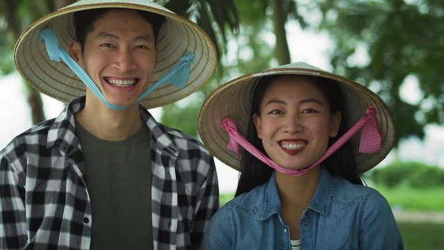 Handheld view of cheerful Vietnamese couple. Shot with RED helium camera in 8K