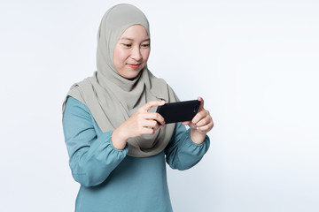 Muslim female using her mobile phone.