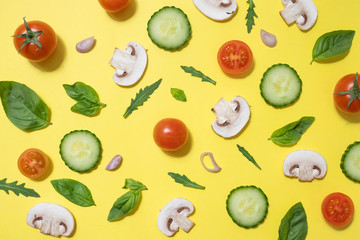Vegetable salad pattern on yellow. Ingredients for vegan food