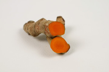 Turmeric root extract on a white background is used as a tonic for the body and food ingredients.