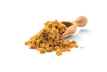 Natural unrefined brown sugar in scoop on white background