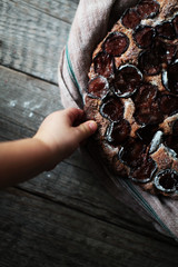 plum cake with little child's hand