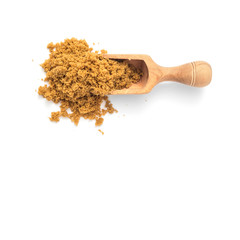 Natural unrefined brown sugar in scoop on white background