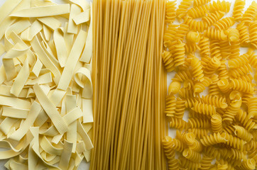 Top view and closeup of various types of italian pasta as a background