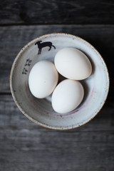 eggs in bowl on wooden table