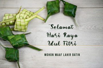Eid Mubarak celebration card translate in Bahasa Indonesia or Malay language - Selamat Hari Raya Idul Fitri. Mohon maaf lahir batin.. With frame background of Ketupat indonesian traditional food.