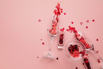 Valentine's day drinks glasses with red heart confetti.