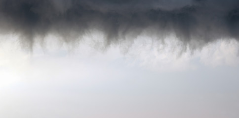 cloudscape background of stormy dark clouds with copy space