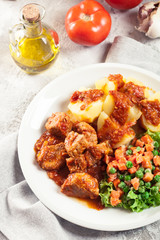 Braised pork meat stew served with potatoes