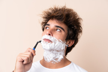 Young handsome man shaving his beard