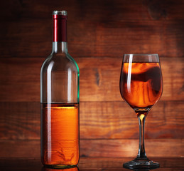 incomplete bottle with wine and goblet