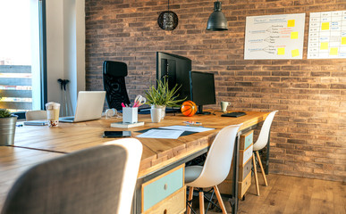 Interior of industrial style coworking office with various workplaces