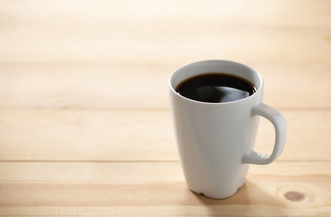 Coffee cup on a blurred wooden board background And free space for entering text