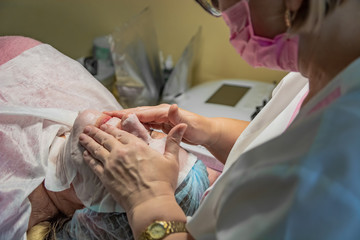 Non-invasive face carboxytherapy in a beauty salon. It is performed for an age woman. Non-injection...