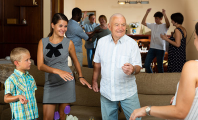 Big family dancing in living room