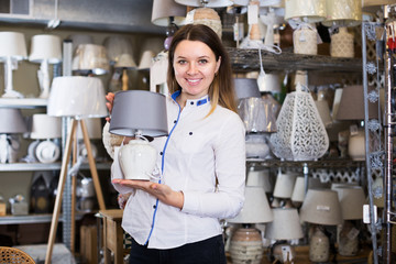 Woman demonstraiting lamp in store