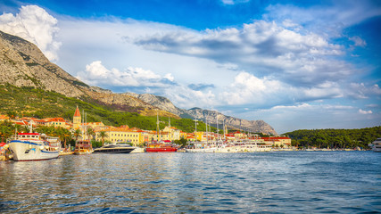 Fototapeta na wymiar Famous Adriatic resort Makarska with picturesque harbor and touristic boats