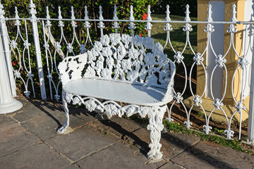 Beautiful white metal carved bench in the park in Trinidad, Cuba