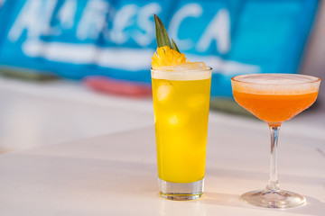 Cold pineapple margarita and pina colada cocktails at bar background.