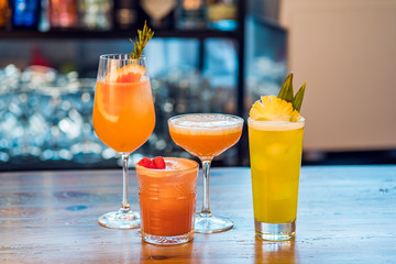 Selection of alcoholic cocktails at bar background.