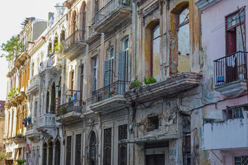 Old facade of houses with balconies on the street in Havana, Cuba