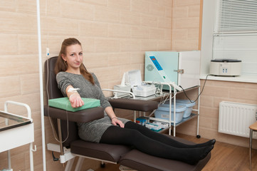 Girl takes blood tests.  Female with a dropper