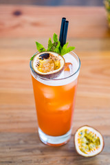 Top view of a passion fruit hurricane cocktail in a tall glass.