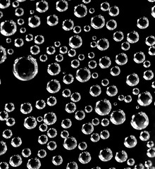 Air balls in water on a black background